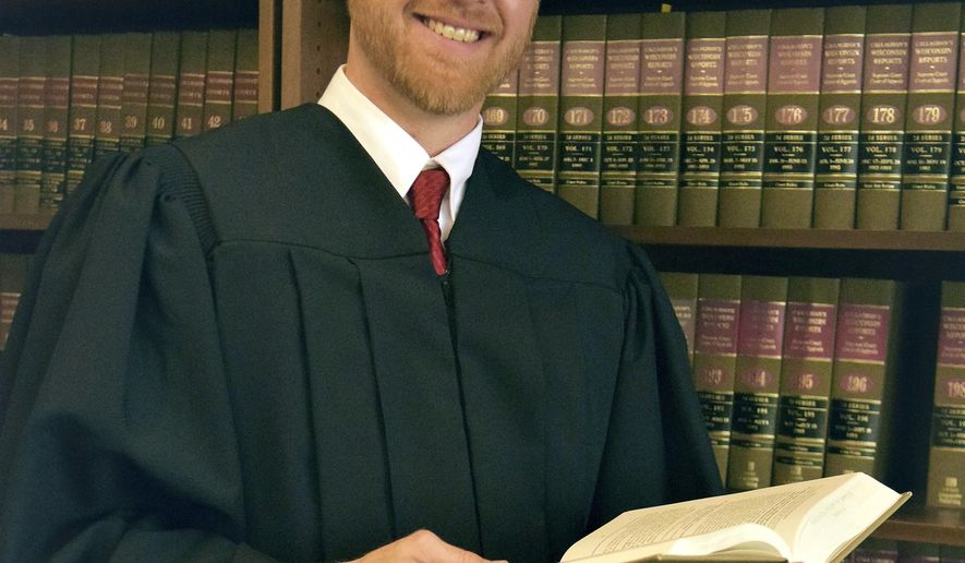 This photo provided by Brian Hagedorn shows conservative state appeals court Judge Brian Hagedorn, the former chief legal counsel for Republican Gov. Scott Walker, who launched his candidacy for Wisconsin Supreme Court on Thursday, Aug. 16, 2018. (Brian Hagedorn via AP)