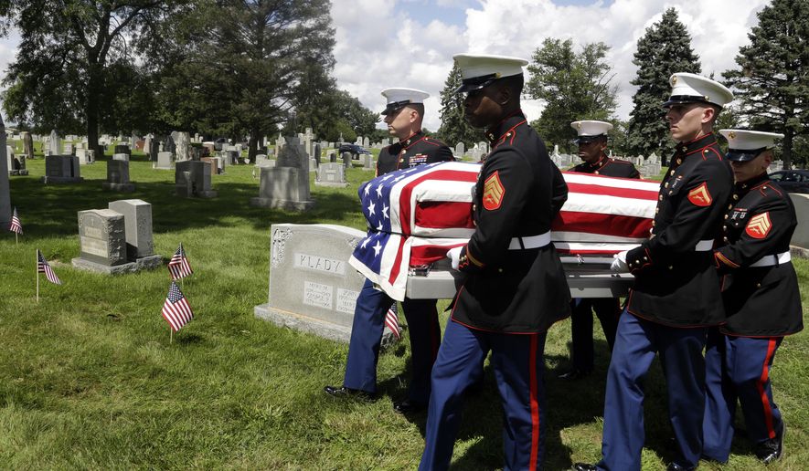 A Marine honor guard carries the remains of Emil Ragucci at the Holy Sepulcher cemetery Tuesday Aug. 14, 2018, in Philadelphia. Nearly 70 years after Ragucci was killed in WWII on the Pacific atoll of Tarawa, his remains were returned home to the Philadelphia area for burial. Two of Emil's brothers, Dominic and Victor Ragucci, attended the service. (AP Photo/Jacqueline Larma)
