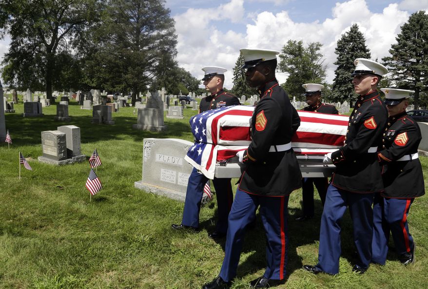 A Marine honor guard carries the remains of Emil Ragucci at the Holy Sepulcher cemetery Tuesday Aug. 14, 2018, in Philadelphia. Nearly 70 years after Ragucci was killed in WWII on the Pacific atoll of Tarawa, his remains were returned home to the Philadelphia area for burial. Two of Emil's brothers, Dominic and Victor Ragucci, attended the service. (AP Photo/Jacqueline Larma)
