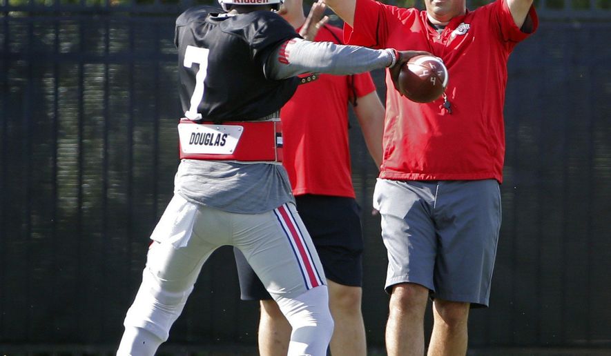 Ohio State acting head coach Ryan Day watches quarterback Dwayne Haskins (7) throw during NCAA college football practice at Woody Hayes Athletic Center in Columbus, Ohio, Tuesday, Aug. 7, 2018. (Kyle Robertson/The Columbus Dispatch via AP)