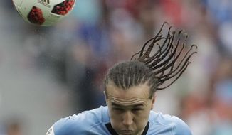 FILE - In this file photo dated Friday, July 6, 2018, Uruguay&#39;s Diego Laxalt during the quarterfinal match between Uruguay and France at the 2018 soccer World Cup in the Nizhny Novgorod Stadium, in Nizhny Novgorod, Russia.  AC Milan has signed midfielder Diego Laxalt on deadline day for the summer transfer window, following his standout performances for Uruguay at the recent soccer World Cup. (AP Photo/Petr David Josek, FILE)