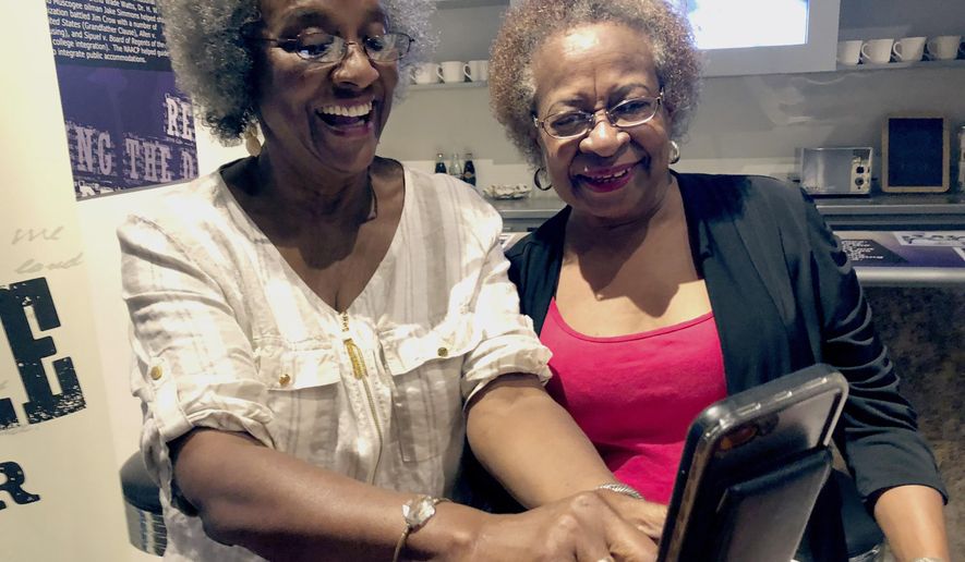 Gwendolyn Fuller Mukes, left, and Marilyn Luper Hildreth pose for a selfie at the Oklahoma History Center in Oklahoma City on Friday, Aug. 17, 2018. Both received the Tulsa-based Woody Guthrie Center's Oklahoma Changing World Prize for their roles in an Aug. 19, 1958, sit-in at an Oklahoma City drug store that ushered in the civil rights movement in the state. (AP Photo/Adam Kealoha Causey)