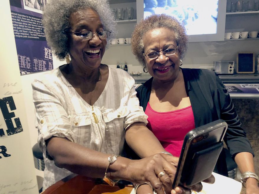 Gwendolyn Fuller Mukes, left, and Marilyn Luper Hildreth pose for a selfie at the Oklahoma History Center in Oklahoma City on Friday, Aug. 17, 2018. Both received the Tulsa-based Woody Guthrie Center's Oklahoma Changing World Prize for their roles in an Aug. 19, 1958, sit-in at an Oklahoma City drug store that ushered in the civil rights movement in the state. (AP Photo/Adam Kealoha Causey)