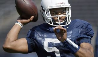 FILE - In this April 14, 2018, file photo, quarterback David Pindell warms up before Connecticut&#39;s annual spring NCAA college football game in East Hartford, Conn. UConn will host Central Florida to open the regular season on Thursday night, Aug. 30. (AP Photo/Jessica Hill, File)