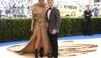 FILE - In this May 1, 2017 file photo, Priyanka Chopra, left, and Nick Jonas attend The Metropolitan Museum of Art&#39;s Costume Institute benefit gala celebrating the opening of the Rei Kawakubo/Comme des Garçons: Art of the In-Between exhibition in New York.  The couple announced on their respective Instagram accounts that they are engaged, Saturday, Aug. 18, 2018. Each posted the same picture, a close-up of them gazing lovingly at each other, an engagement ring on Chopra’s finger.  (Photo by Charles Sykes/Invision/AP, File)