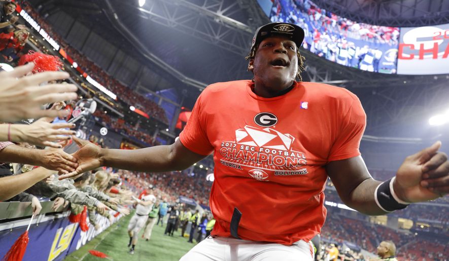 FILE - In this Dec. 2, 2017, file photo, Georgia offensive lineman Isaiah Wilson celebrates a Georgia win over Auburn in the Southeastern Conference championship NCAA college football game in Atlanta. Wilson has been working with Georgia’s first-team offense at right tackle for much of preseason camp as the Bulldogs attempt to replace New England Patriots first-round draft pick Isaiah Wynn, who was the starting left tackle last season. (AP Photo/David Goldman, File)