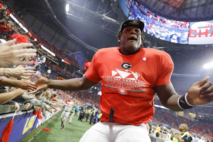 FILE - In this Dec. 2, 2017, file photo, Georgia offensive lineman Isaiah Wilson celebrates a Georgia win over Auburn in the Southeastern Conference championship NCAA college football game in Atlanta. Wilson has been working with Georgia’s first-team offense at right tackle for much of preseason camp as the Bulldogs attempt to replace New England Patriots first-round draft pick Isaiah Wynn, who was the starting left tackle last season. (AP Photo/David Goldman, File)