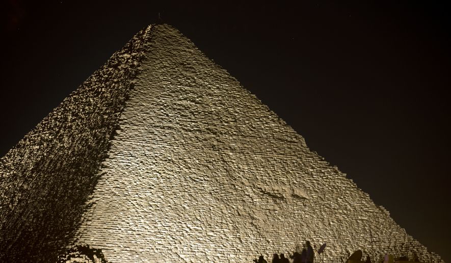 Visitors film the light on the historical site of Giza Pyramids as they celebrate the New Year in Egypt, Monday, Jan. 1, 2018. (AP Photo/Amr Nabil) ** FILE **
