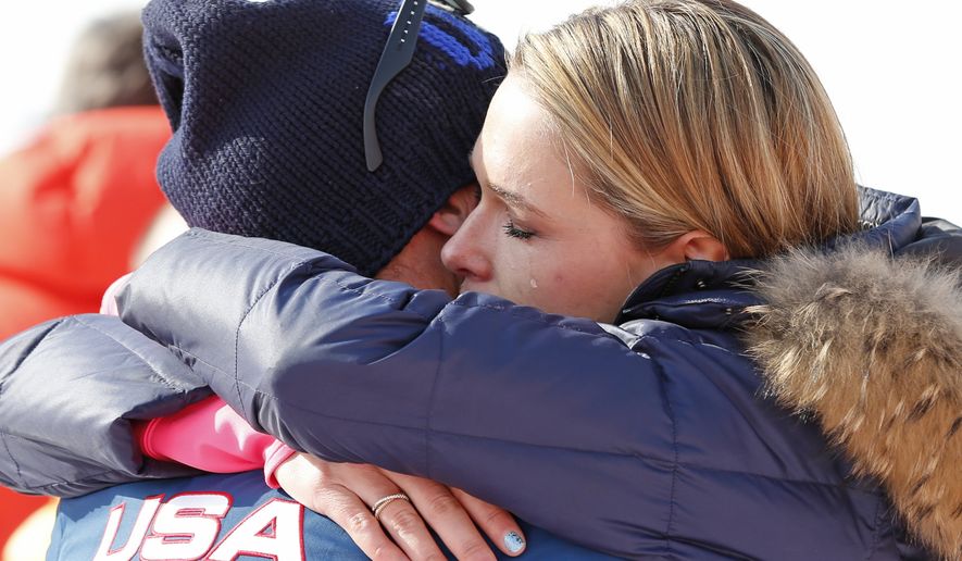 Morgan Miller hugs her husband, United States&#x27; Bode Miller after he took part in the flower ceremony for the men&#x27;s super-G for his joint bronze medal at the Sochi 2014 Winter Olympics, Sunday, Feb. 16, 2014, in Krasnaya Polyana, Russia. (AP Photo/Gero Breloer)