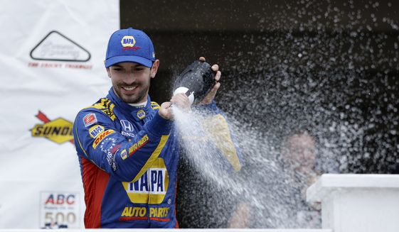 Alexander Rossi celebrates in Victory Lane after winning the IndyCar auto race at Pocono Raceway, Sunday, Aug. 19, 2018, in Long Pond, Pa. (AP Photo/Matt Slocum)
