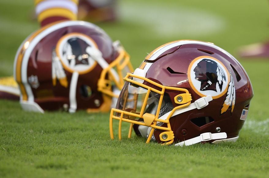 A Washington Redskins football helmet lies on the field before a preseason NFL football game against the New York Jets, Thursday, Aug. 16, 2018, in Landover, Md. (AP Photo/Nick Wass) ** FILE **