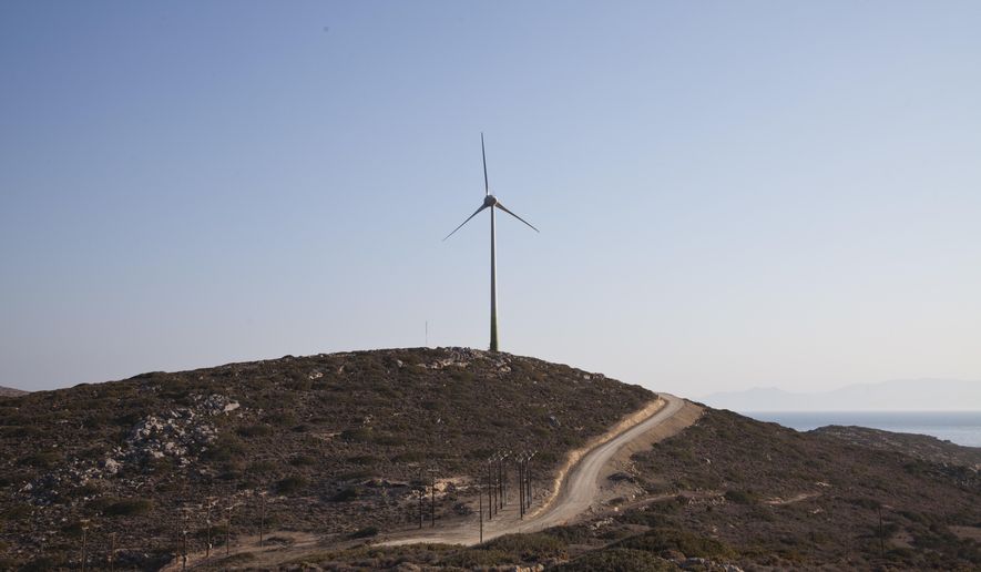 In this Thursday, Aug. 9, 2018 photo is seen a wind turbine on the Aegean island of Tilos, Greece.  When the blades of the 800 kilowatt wind turbine start turning, Tilos will become the first island in the Mediterranean to run exclusively on wind and solar power, feeding the needs of its population of some 400 people in winter, and some 3000 in summer.  (AP Photo/ Iliana Mier)