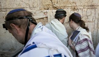 In this Thursday, Feb. 25, 2016, file photo, American and Israeli Reform rabbis pray at the Western Wall, the holiest site where Jews can pray in Jerusalem&#39;s old city. Israel&#39;s recent detentions of Jewish-American critics entering the country is shining a spotlight on a growing gulf between the country&#39;s hard-line government and the predominantly liberal Jewish community in the U.S. (AP Photo/Sebastian Scheiner, File)