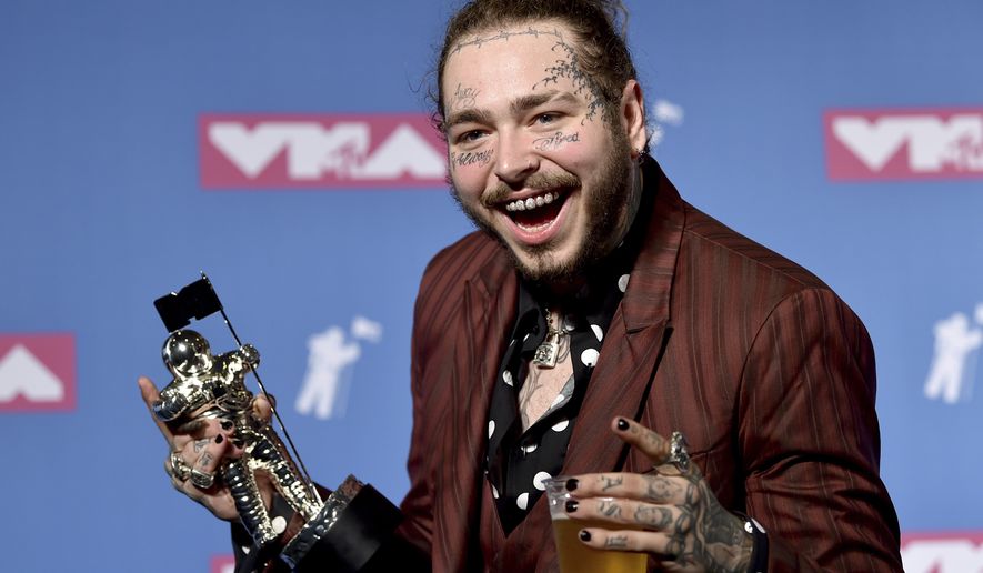 Post Malone poses with the award for song of the year for &quot;Rockstar&quot; in the press room at the MTV Video Music Awards at Radio City Music Hall on Monday, Aug. 20, 2018, in New York. (Photo by Evan Agostini/Invision/AP)
