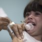 In this file photo dated Monday, Aug. 6, 2018, a child receives a measles vaccination in Rio de Janeiro, Brazil.  The World Health Organization (WTO) said Monday Aug. 20, 2018, the number of measles cases in Europe jumped sharply during the first six months of 2018 with at least 37 people dead from the disease, and called for increased immunization rates to prevent an endemic.  (AP Photo/Leo Correa, FILE)