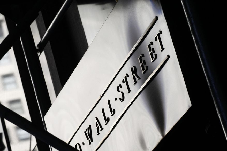 FILE - This July 15, 2013, file photo, shows a sign for Wall Street outside the New York Stock Exchange. The U.S. stock market opens at 9:30 a.m. EDT on Monday, Aug. 20, 2018. (AP Photo/Mark Lennihan, File)