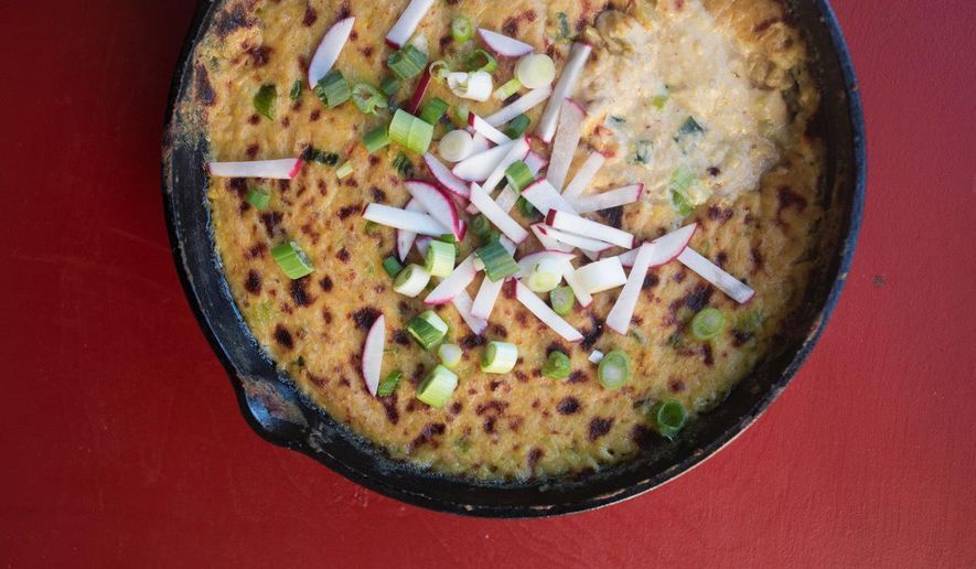 This November 2017 photo shows hot corn queso dip in New York. This dish is from a recipe by Katie Workman. (Lucy Beni via AP)