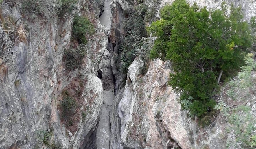 A view of the Raganello Gorge in Civita, Italy, Monday, Aug. 20, 2018. Italy’s civil protection agency says at least five people have been killed when a rain-swollen river flooded a gorge in the southern region of Calabria. The Italian news agency ANSA reported Monday that 12 people were brought to safety in the flash flood. It was unclear how many people were missing. The flood hit a group of hikers in the Raganello Gorge. (Antonio Iannicelli/ANSA via AP)