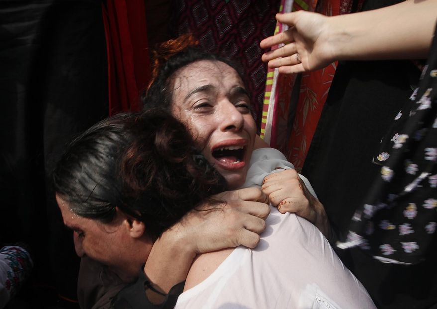 A Pakistani transgender woman mourns the death of her colleague, during a protest in Peshawar, Pakistan, Monday, Aug. 20, 2018. A transgender person was shot dead on Thursday night, police said. (AP Photo/Muhammad Sajjad)