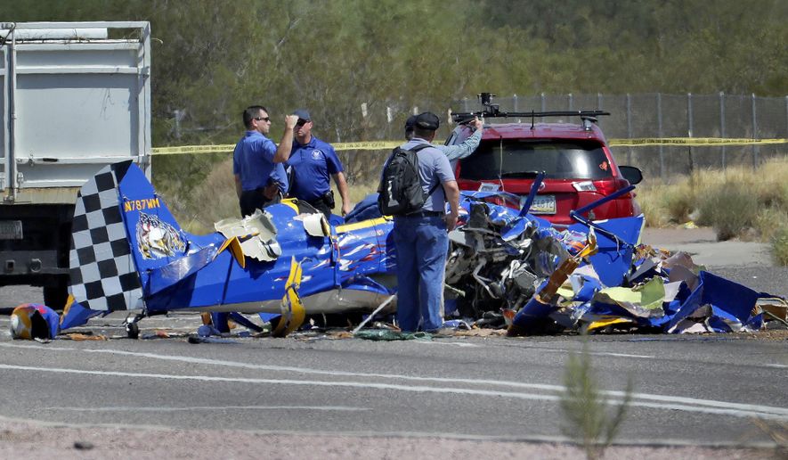 The wreckage of a small plane sits in an intersection Monday, Aug. 20, 2018, in Phoenix. The plane went down near the city&#x27;s Deer Valley Airport. (AP Photo/Matt York)