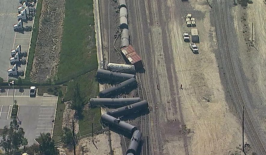 In this aerial image taken from video provided by K-ABC, shows a freight train derailment in San Bernardino, Calif. on Tuesday, Aug. 21, 2018. The San Bernardino County Fire Department says 13 tank cars went off the rails on the south side of the Cajon Pass. The department says at least two of the tankers are leaking but efforts are still underway to identify what product the train was carrying. Authorities say no injuries have been reported at the scene. (K-ABC via AP)