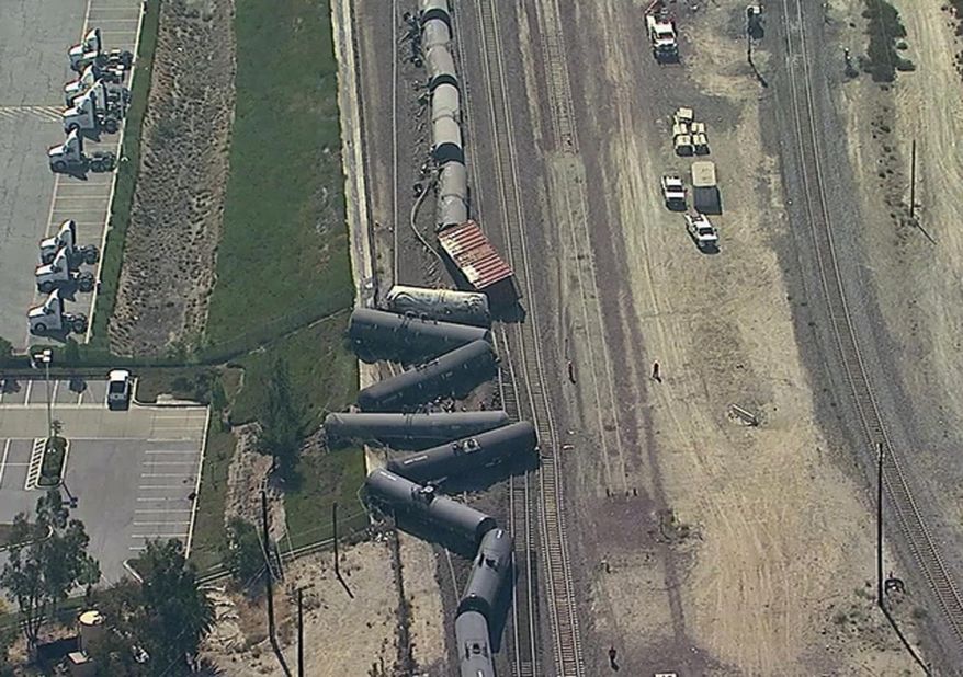 In this aerial image taken from video provided by K-ABC, shows a freight train derailment in San Bernardino, Calif. on Tuesday, Aug. 21, 2018. The San Bernardino County Fire Department says 13 tank cars went off the rails on the south side of the Cajon Pass. The department says at least two of the tankers are leaking but efforts are still underway to identify what product the train was carrying. Authorities say no injuries have been reported at the scene. (K-ABC via AP)
