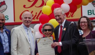D.C. Council Chairman Phil Mendelson (left), councilmember Jack Evans and councilmember Brianne Nadeau presented Ben&#39;s Chili Bowl co-founder Virginia Ali with a ceremonial resolution declaring Aug. 22 as &quot;Ben&#39;s Chili Bowl Day&quot; in the District. (Julia Airey/THE WASHINGTON TIMES)