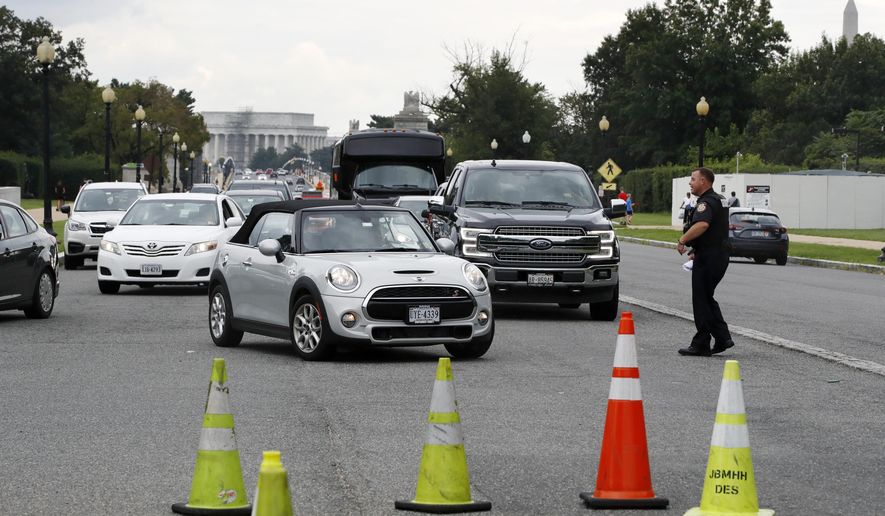 Cars are turned away from the entrance of Arlington National Cemetery, in Arlington, Va., Wednesday, Aug. 22, 2018. Arlington National Cemetery has been evacuated as authorities respond to a bomb threat. The cemetery says it will be closed to the public for the rest of the day, but all funerals will be conducted as scheduled. (AP Photo/Jacquelyn Martin)