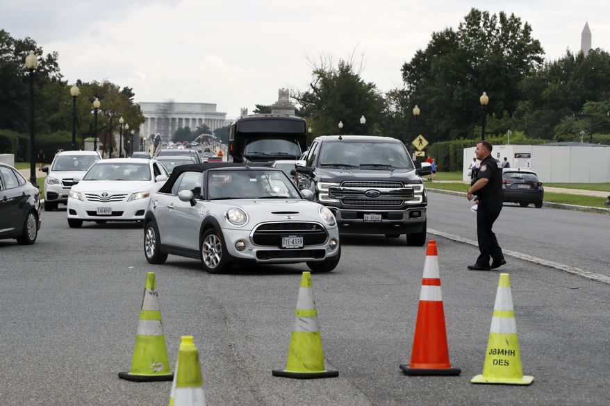 Cars are turned away from the entrance of Arlington National Cemetery, in Arlington, Va., Wednesday, Aug. 22, 2018. Arlington National Cemetery has been evacuated as authorities respond to a bomb threat. The cemetery says it will be closed to the public for the rest of the day, but all funerals will be conducted as scheduled. (AP Photo/Jacquelyn Martin)