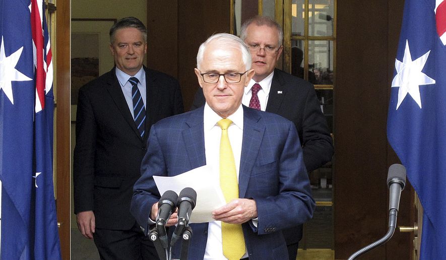 Australia's Finance Minister Mathias Cormann, left, Prime Minister Malcolm Turnbull, center, and Treasurer Scott Morrison arrive to address media at Parliament House in Canberra, Australia, Wednesday, Aug. 22, 2018. The two ministers declared their support for Turnbull remaining prime minister as another lawmaker prepares a leadership challenge. (AP Photo/Rod McGuirk)