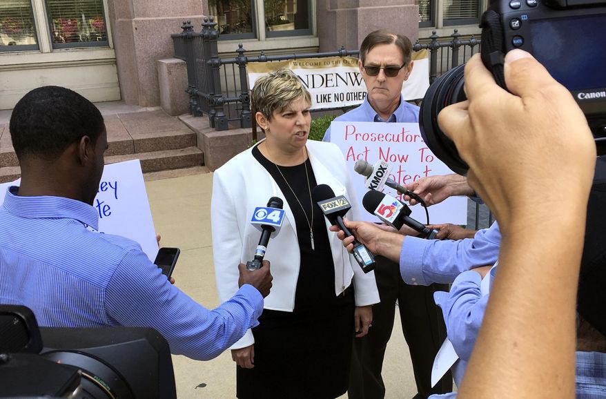 Attorney Nicole Gorovsky speaks to reporters in St. Louis on Wednesday, Aug. 22, 2018, with clergy sex abuse advocate and victim David Clohessy by her side. Gorovsky, Clohessy and Mary Ellen Kruger spoke outside the St. Louis office of Attorney General Josh Hawley, calling for a wide-scale investigation of sex abuse by priests in Missouri. Kruger's son committed suicide in 1991, about five years after he was abused by a priest and another man at a Catholic high school. (AP Photo/Jim Salter)