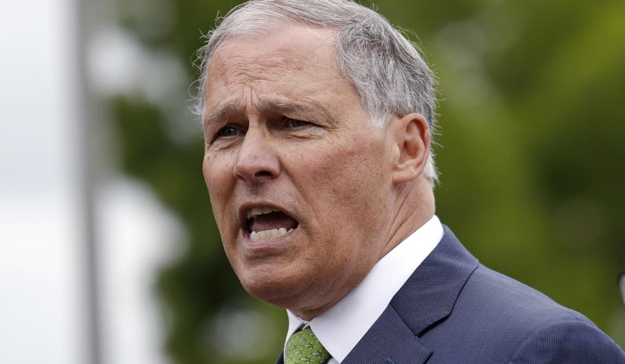 FILE - In this June 21,2018, file photo, Washington Gov. Jay Inslee speaks at a news conference in SeaTac, Wash. Inslee says the state plans to sue the Trump administration over its proposal to dismantle Obama-era pollution rules that would have increased federal regulation of emissions of coal-fired power plants. Inslee, a Democrat, told reporters Wednesday, Aug. 22, 2018, that the Environmental Protection Agency plan threatens lives and is also illegal. (AP Photo/Elaine Thompson, File)