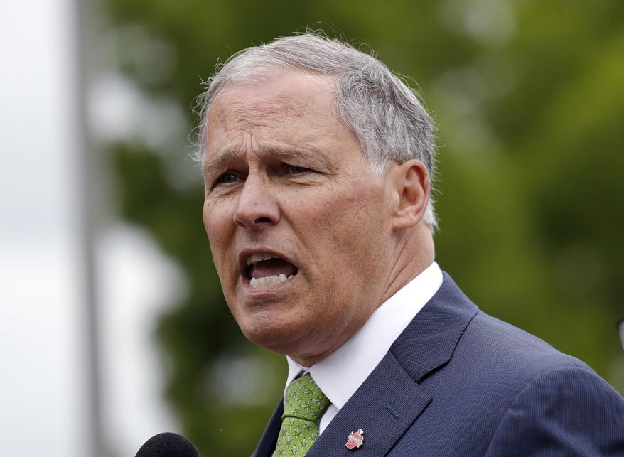 FILE - In this June 21,2018, file photo, Washington Gov. Jay Inslee speaks at a news conference in SeaTac, Wash. Inslee says the state plans to sue the Trump administration over its proposal to dismantle Obama-era pollution rules that would have increased federal regulation of emissions of coal-fired power plants. Inslee, a Democrat, told reporters Wednesday, Aug. 22, 2018, that the Environmental Protection Agency plan threatens lives and is also illegal. (AP Photo/Elaine Thompson, File)