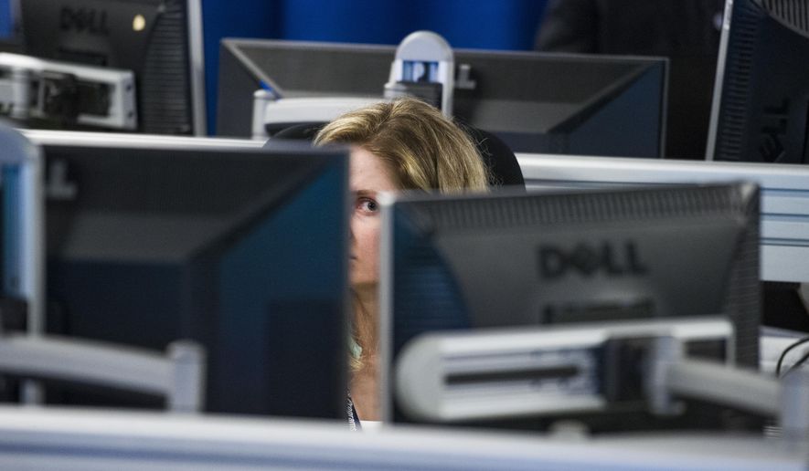 A worker is surrounded by computer monitors in the Department of Homeland Security&#39;s National Cybersecurity and Communications Integration Center (NCCIC) in Arlington, Va., Wednesday, Aug. 22, 2018. The center serves as the hub for the federal government&#39;s cyber situational awareness, incident response, and management center for any malicious cyber activity. (AP Photo/Cliff Owen)