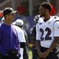 FILE - In this July 19, 2018, file photo, Baltimore Ravens head coach John Harbaugh, left, chats with cornerback Jimmy Smith (22) during an NFL football training camp practice at the team&#39;s headquarters in Owings Mills, Md. Jimmy Smith has been suspended for four games without pay for violating the NFL&#39;s personal conduct policy. The suspension, announced Tuesday, Aug. 21, 2018, stems from Smith&#39;s behavior toward his ex-girlfriend. (AP Photo/Patrick Semansky, File)
