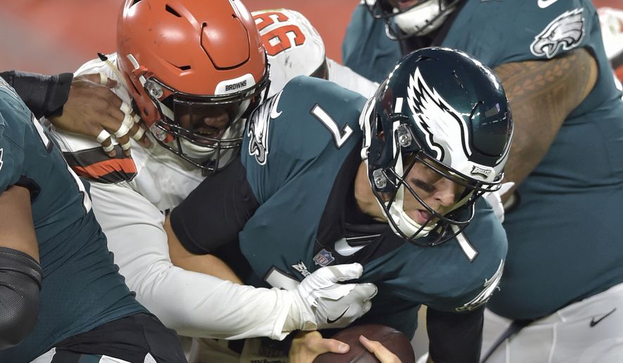 Cleveland Browns defensive tackle Caleb Brantley (99) sacks Philadelphia Eagles quarterback Nate Sudfeld (7) during the second half of an NFL preseason football game Thursday, Aug. 23, 2018, in Cleveland. (AP Photo/David Richard)