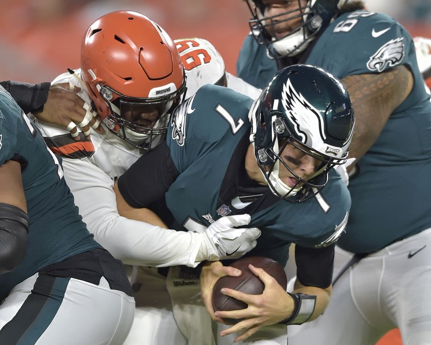 Cleveland Browns defensive tackle Caleb Brantley (99) sacks Philadelphia Eagles quarterback Nate Sudfeld (7) during the second half of an NFL preseason football game Thursday, Aug. 23, 2018, in Cleveland. (AP Photo/David Richard)