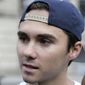 David Hogg, a survivor of the school shooting at Marjory Stoneman Douglas High School, in Parkland, Florida, speaks with reporters before walking in a planned 50-mile march, Thursday, Aug. 23, 2018, in Worcester, Mass.  (AP Photo/Steven Senne)
