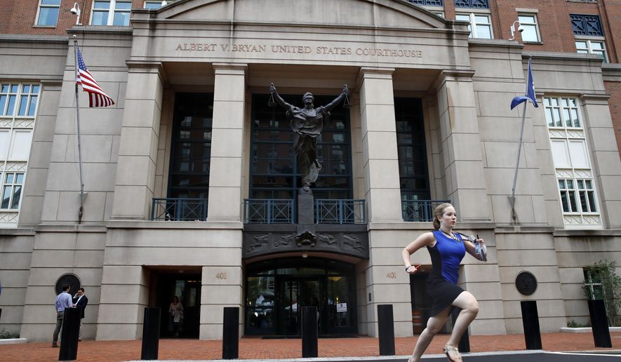 Cassie Semyon, 21, an intern for NBC News, runs from the courthouse with results outside of federal court as jury deliberations are announced in the trial of the former Donald Trump campaign chairman Paul Manafort in Alexandria, Va., Tuesday, Aug. 21, 2018. (AP Photo/Jacquelyn Martin)