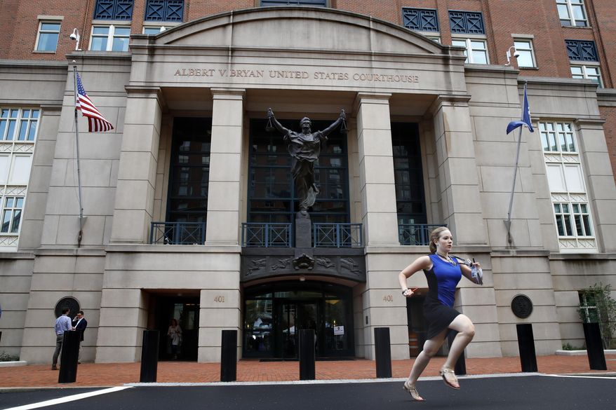 Cassie Semyon, 21, an intern for NBC News, runs from the courthouse with results outside of federal court as jury deliberations are announced in the trial of the former Donald Trump campaign chairman Paul Manafort in Alexandria, Va., Tuesday, Aug. 21, 2018. (AP Photo/Jacquelyn Martin)