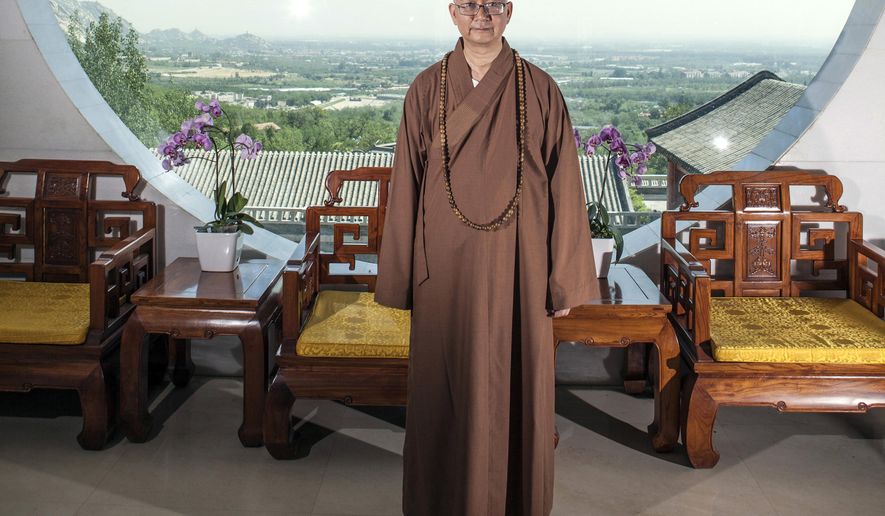 FILE - In this July 3, 2015, file photo, Abbot Xuecheng of the Beijing Longquan Temple poses for a photo in one of the temple buildings in Beijing, China. According to a statement issued Thursday, Aug. 23, 2018, Chinese police have opened an investigation into sexual misconduct allegations against one of the country&#39;s best-known Buddhist monks whose case has highlighted the growth of the #MeToo movement in China. (Chinatopix via AP, File)