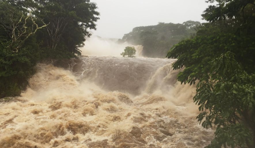 This photo provided by Jessica Henricks shows flooding Thursday, Aug. 23, 2018, Wailuku River near Hilo, Hawaii. Hurricane Lane brought torrential rains to Hawaii&#x27;s Big Island and Maui before the storm was expected to hit Oahu. A powerful hurricane unleashed torrents of rain and landslides Thursday that blocked roads on the rural Big Island but didn&#x27;t scare tourists away from surfing and swimming at popular Honolulu beaches still preparing get pummeled by the erratic storm. (Jessica Henricks via AP)