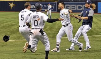 Tampa Bay Rays&#39; Matt Duffy (5), Mallex Smith (0), Kevin Kiermaier and Ryne Stanek celebrate the team&#39;s 4-3 win over the Kansas City Royals during a baseball game Thursday, Aug. 23, 2018, in St. Petersburg, Fla. (AP Photo/Steve Nesius)