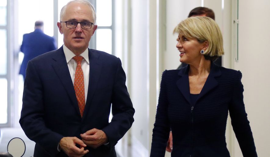 Incumbent Australian Prime Minister Malcolm Turnbull, left, walks with Foreign Minister Julie Bishop after a party meeting in Canberra, Australia Friday, Aug. 24, 2018. Australia government lawmakers on Friday elected Treasurer Scott Morrison as the next prime minister in a ballot that continues an era of extraordinary political instability. (David Gray/Pool Photo via AP)