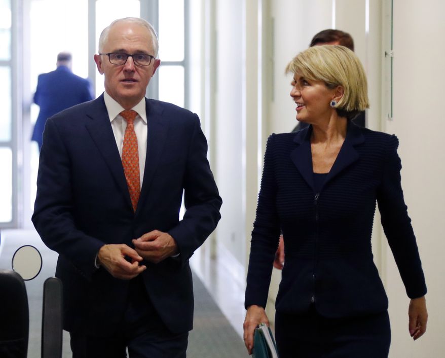 Incumbent Australian Prime Minister Malcolm Turnbull, left, walks with Foreign Minister Julie Bishop after a party meeting in Canberra, Australia Friday, Aug. 24, 2018. Australia government lawmakers on Friday elected Treasurer Scott Morrison as the next prime minister in a ballot that continues an era of extraordinary political instability. (David Gray/Pool Photo via AP)