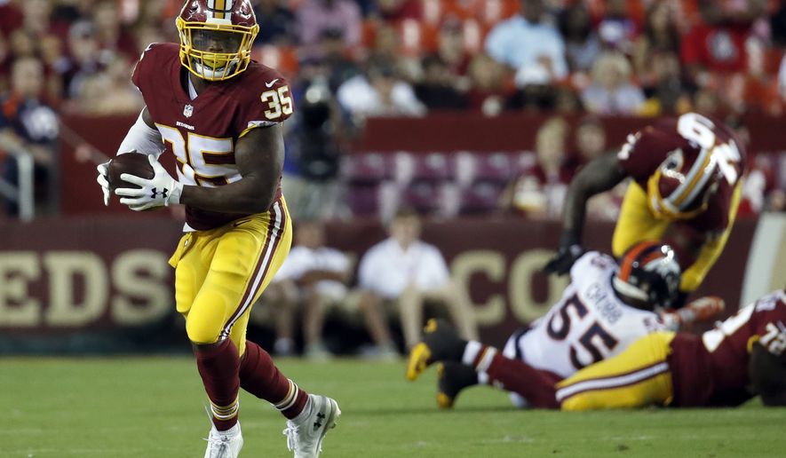 Washington Redskins running back Kapri Bibbs (35) runs with the ball during the first half of a preseason NFL football game against the Denver Broncos, Friday, Aug. 24, 2018, in Landover, Md. (AP Photo/Alex Brandon)