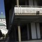 This photo shows the Serbian National Library and St. Sava temple in downtown Belgrade, Serbia, Friday, Aug. 24, 2018. A poisonous gas leak killed two men Friday at the National Library in the Serbian capital of Belgrade, police said. (AP Photo/Darko Vojinovic)