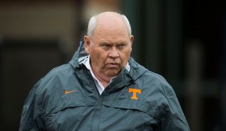 FILE - In this March 20, 2018, file photo, Tennessee&#39;s athletic director Phillip Fulmer watches during the first day of spring NCAA college football practice, in Knoxville, Tenn. Tennessee athletic director Phillip Fulmer says his new position didn’t require much in the way of on-the-job training. Fulmer was hired in December to salvage a football coaching search that had gone awry. Fulmer, a Tennessee alum who coached the Volunteers’ football team to the 1998 national title, understands his No. 1 goal is to make sure the football program becomes competitive again. Now that he’s had nearly nine months on the job and has watched first-year football coach Jeremy Pruitt at work, Fulmer’s more comfortable than ever in his new role. (Caitie McMekin/Knoxville News Sentinel via AP, File)