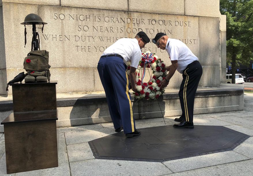 Lt. Col. Jeffrey Samon, left, commander of the Rhode Island National Guard 103rd Field Artillery Battalion and retired Brig. Gen. Richard J. Valente, a former battalion commander, lay a wreath at the World War I monument, Friday, Aug. 24, 2018, in Providence, R.I. The unit held the ceremony to memorialize their predecessors' service and sacrifice during the conflict. The centennial of the war's end will be on Sunday, Nov. 11. (AP Photo/Jennifer McDermott)