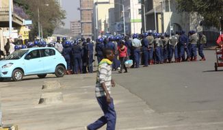 Armed Riot police patrol on a street, in Harare, Friday, Aug. 24, 2018.  Zimbabwe&#39;s constitutional court was set to rule Friday afternoon on the main opposition&#39;s challenge to the results of last month&#39;s historic presidential election. Security was tight in the capital, Harare, as the court will determine whether President Emmerson Mnangagwa&#39;s narrow victory is valid. The opposition claims vote-rigging and seeks either a fresh election or a declaration that its candidate, 40-year-old Nelson Chamisa, won. (AP Photo/Tsvangirayi Mukwazhi)